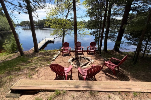 Lakeside cabin with a firepit, sunroom, & seasonal dock