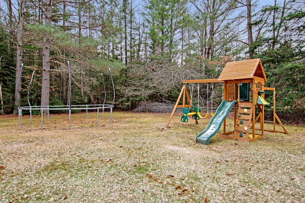 Lakefront Home with a Private Dock, Deck, Fireplace, Spacious Yard, & Playset