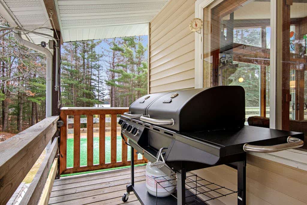 Lakefront Home with a Private Dock, Deck, Fireplace, Spacious Yard, & Playset