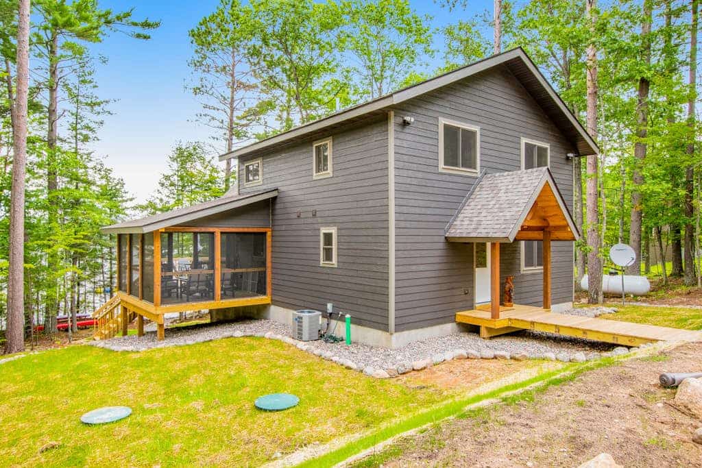 Gorgeous lake home with private pier, beach, firepit, deck, & grill + water toys