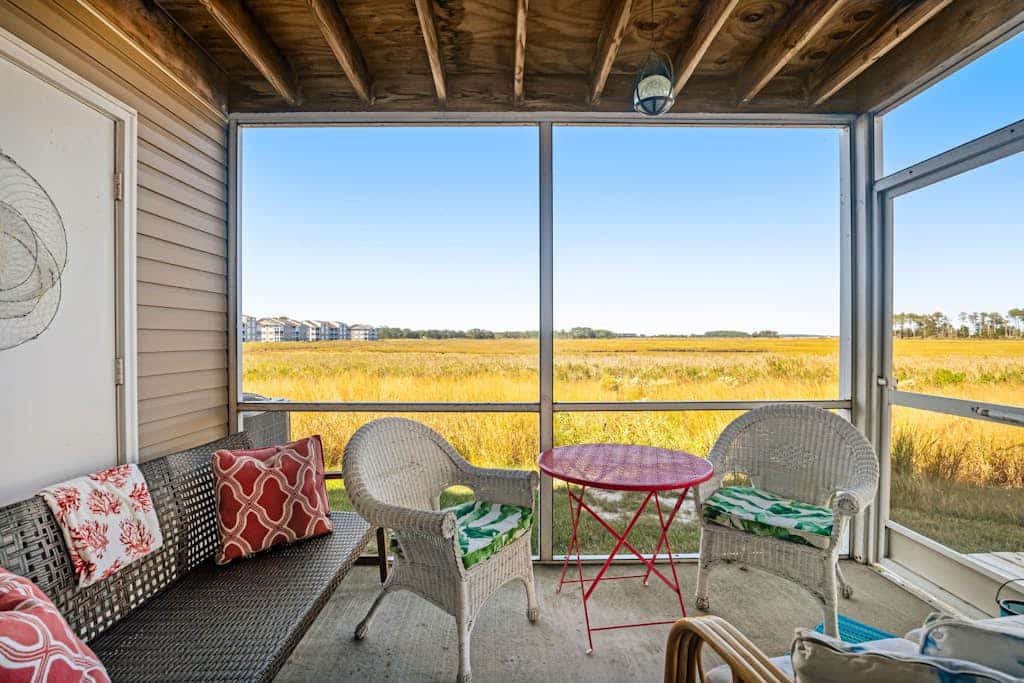 Bethany Bay condo with pool, fireplace, screened porch & AC