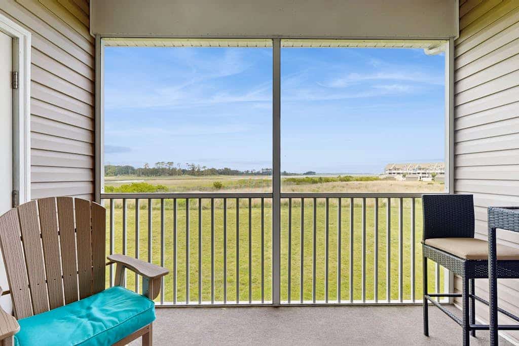 Bethany Bay condo with bay views, athletic courts, pool, fireplace, & balcony