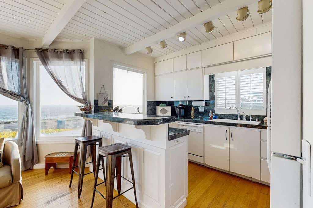 Wake to the sound of crashing waves from this oceanfront perch above Carmet Beach. Your dog will love exploring the coastal trails while you soak in panoramic Pacific views from the deck's Adirondack chairs. This bright 2-bedroom cottage sleeps 6 and sits directly across from the beach. Spud Point's famous crab sandwiches are 3 miles south, Terrapin Creek's acclaimed bistro is 2.7 miles away. Watch the sunset paint the sky from your front-row seat to nature's daily spectacle.