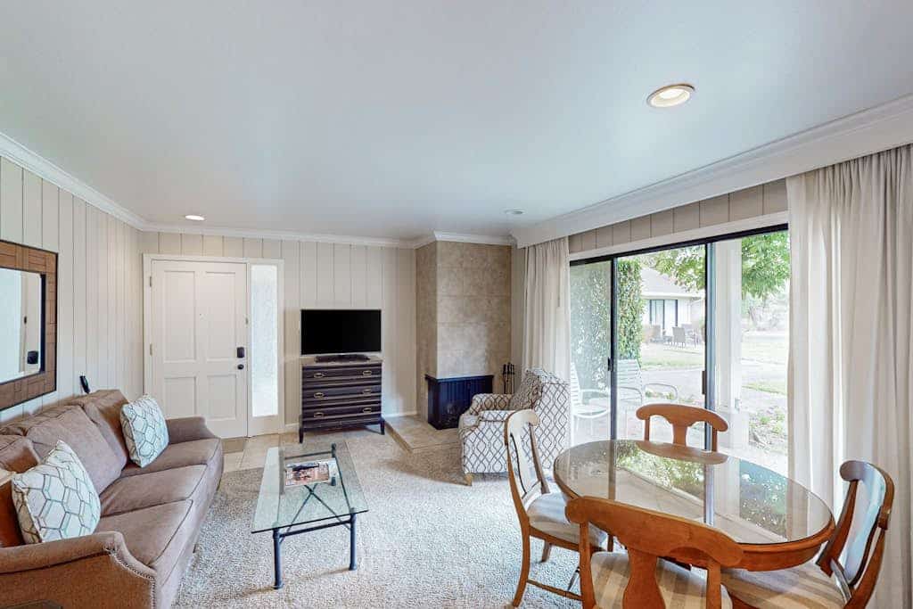 Your ground-floor patio looks straight out over the Silverado driving range, Atlas Peak rising beyond the fairway — this condo sits in the heart of the resort, facing the golf course. Built for couples who want to cook and linger: a full galley kitchen, a wood-burning fireplace, a king master that opens to the patio, and a second, fully enclosed patio for private outdoor evenings. The seasonal heated pool is steps away; Del Dotto and Krupp Brothers are 0.7 miles, downtown Napa 10 minutes south.