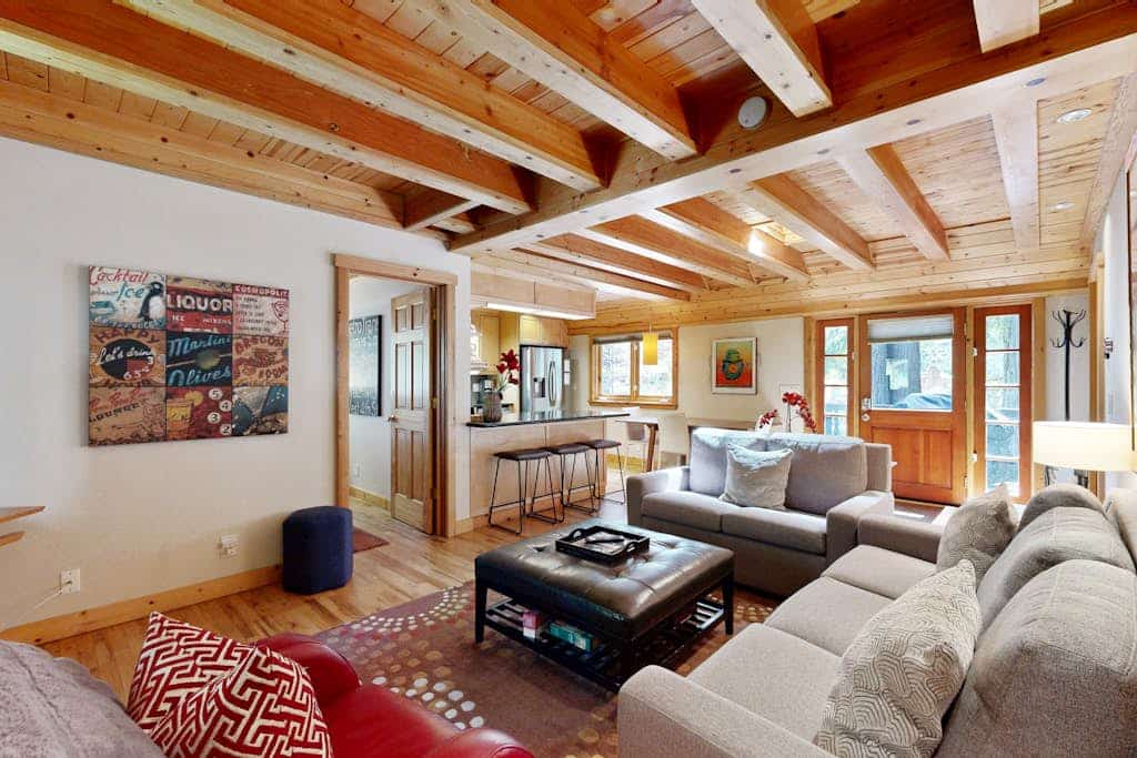 Sink into your private hot tub as redwoods tower overhead, their scent mingling with the woodsmoke from neighboring chimneys. This coral-colored A-frame welcomes you and your pup with contemporary comfort wrapped in classic cabin charm. Room for 6 in two bedrooms plus a sleeper sofa. Just 0.8 miles to Monte Rio Beach and 0.2 miles to Northwood Restaurant. The Russian River's unhurried rhythm sets the pace here — kayaking, golf, and riverside dining all within minutes.