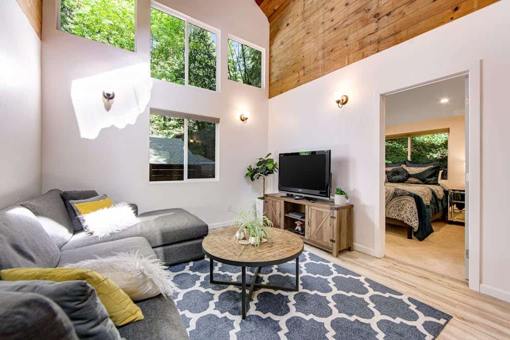 Spiral up to your loft bedroom as sunlight filters through towering redwoods outside every window. This modern canyon hideaway sleeps 6 with three queen beds, a well-equipped kitchen, and a multi-level patio perfect for grilling under string lights. Just 0.3 miles from Rio Nido Roadhouse, 1.6 miles to Armstrong Redwoods trails, and 2 miles to downtown Guerneville's riverside scene. Your Russian River adventure starts where the forest meets comfort.