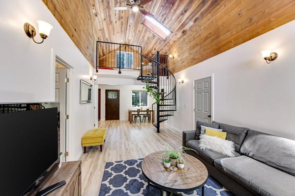 Spiral up to your loft bedroom as sunlight filters through towering redwoods outside every window. This modern canyon hideaway sleeps 6 with three queen beds, a well-equipped kitchen, and a multi-level patio perfect for grilling under string lights. Just 0.3 miles from Rio Nido Roadhouse, 1.6 miles to Armstrong Redwoods trails, and 2 miles to downtown Guerneville's riverside scene. Your Russian River adventure starts where the forest meets comfort.