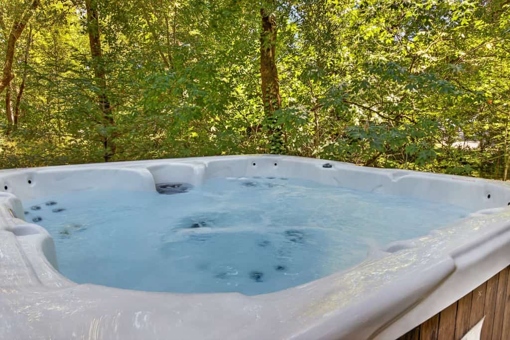 Slip into the hot tub as dusk settles over your private forest sanctuary. This contemporary 3-bedroom retreat sleeps 6 in serene seclusion, with floor-to-ceiling windows framing mature oaks from every room. You're just 0.9 miles from Glen Ellen Star's wood-fired cuisine and Jack London State Historic Park's redwood trails. The deck wraps around towering trees — morning coffee here feels like a meditation.