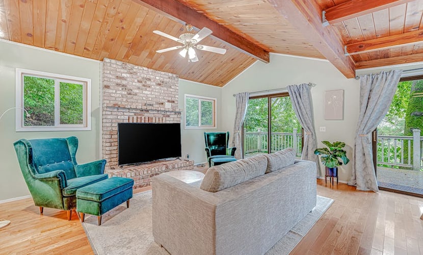 Wake to redwood light filtering across the deck of this Forestville hideaway across the road from the Russian River, five miles north of town and twelve from downtown Healdsburg. A main-level queen bedroom plus a separate exterior-entry studio with its own queen and full bath sleep 4 between two private spaces — built for two couples who want their own coffee at sunrise.