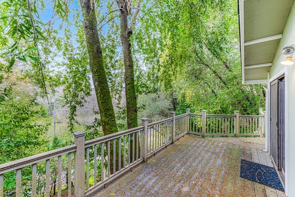 Wake to redwood light filtering across the deck of this Forestville hideaway across the road from the Russian River, five miles north of town and twelve from downtown Healdsburg. A main-level queen bedroom plus a separate exterior-entry studio with its own queen and full bath sleep 4 between two private spaces — built for two couples who want their own coffee at sunrise.