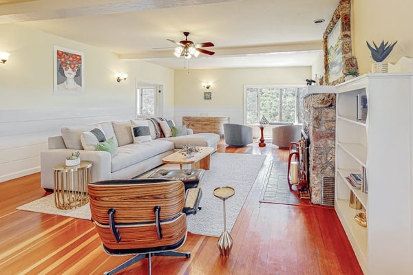 Furnished 30-night-minimum rental on Fitch Mountain, two miles from Healdsburg Plaza. Utilities and Wi-Fi included. Five bedrooms, one and a half baths, own washer and dryer, a desk, air conditioning, and one designated parking spot. A 1940s Camp Rose cottage with a stone fireplace, a separate dining room, a fenced play yard with a swing set, and Russian River valley views from most rooms. Stays of 30 to 90 nights. No pets.