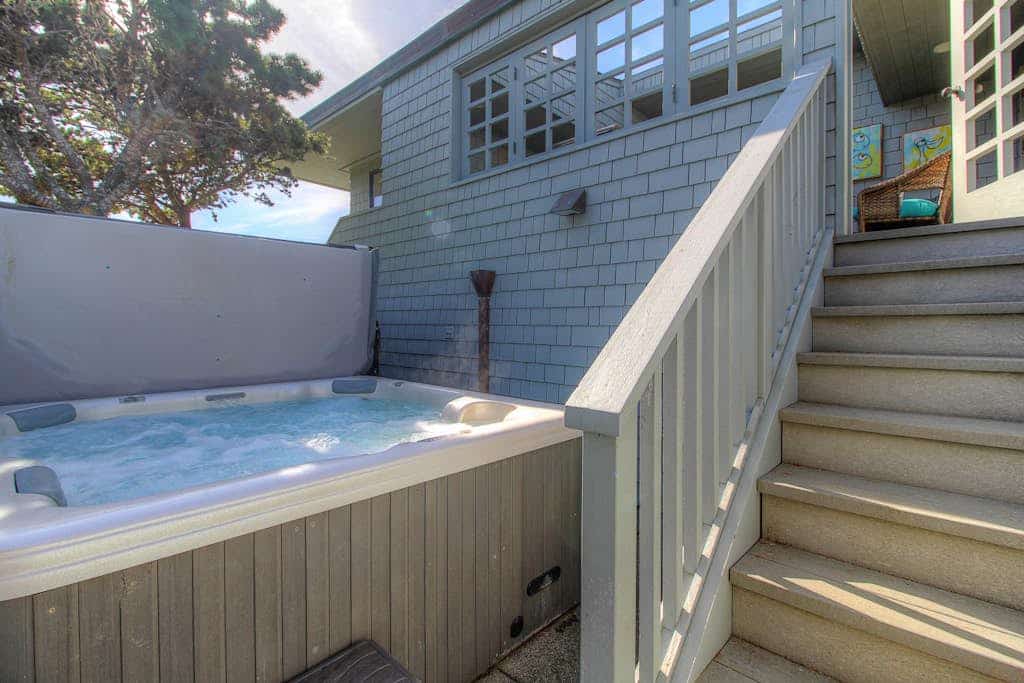 Feel the salt breeze drift across the fairway as you soak in your private hot tub, watching the sun sink into Bodega Bay. This contemporary three-bedroom retreat perches above The Links at Bodega Harbour with sweeping views of ocean, bay, and manicured greens. Room for eight in comfort. Just half a mile from the Pinnacle Gulch Trail and two miles from Doran Beach's protected sands. Your deck becomes the best seat on the Sonoma Coast — where golf course elegance meets wild Pacific beauty.