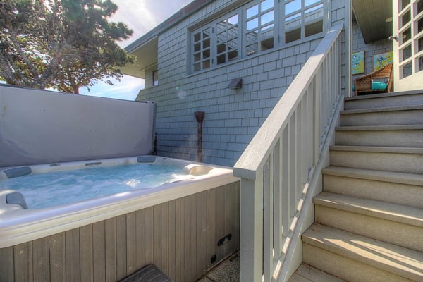 Feel the salt breeze drift across the fairway as you soak in your private hot tub, watching the sun sink into Bodega Bay. This contemporary three-bedroom retreat perches above The Links at Bodega Harbour with sweeping views of ocean, bay, and manicured greens. Room for eight in comfort. Just half a mile from the Pinnacle Gulch Trail and two miles from Doran Beach's protected sands. Your deck becomes the best seat on the Sonoma Coast — where golf course elegance meets wild Pacific beauty.