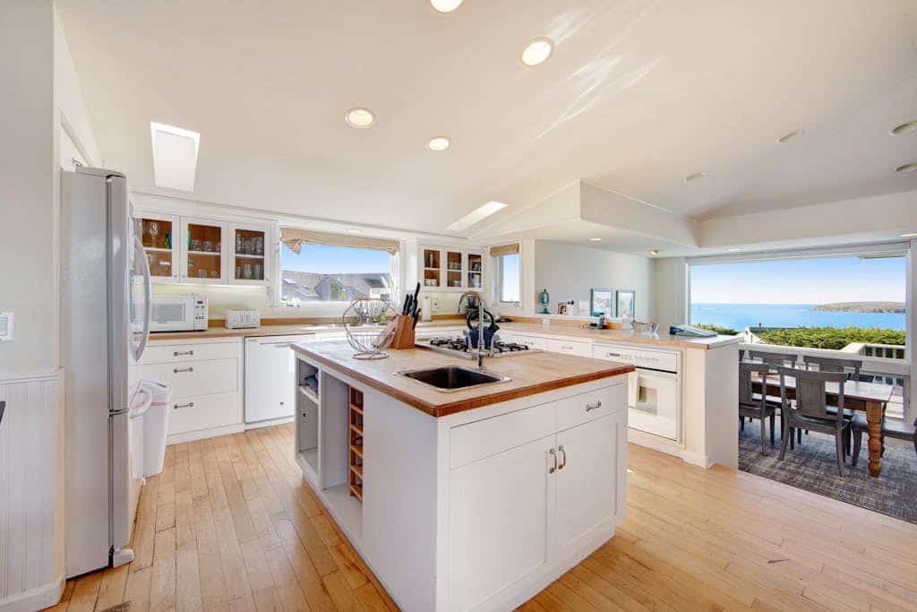 Feel the salt breeze drift across the fairway as you soak in your private hot tub, watching the sun sink into Bodega Bay. This contemporary three-bedroom retreat perches above The Links at Bodega Harbour with sweeping views of ocean, bay, and manicured greens. Room for eight in comfort. Just half a mile from the Pinnacle Gulch Trail and two miles from Doran Beach's protected sands. Your deck becomes the best seat on the Sonoma Coast — where golf course elegance meets wild Pacific beauty.