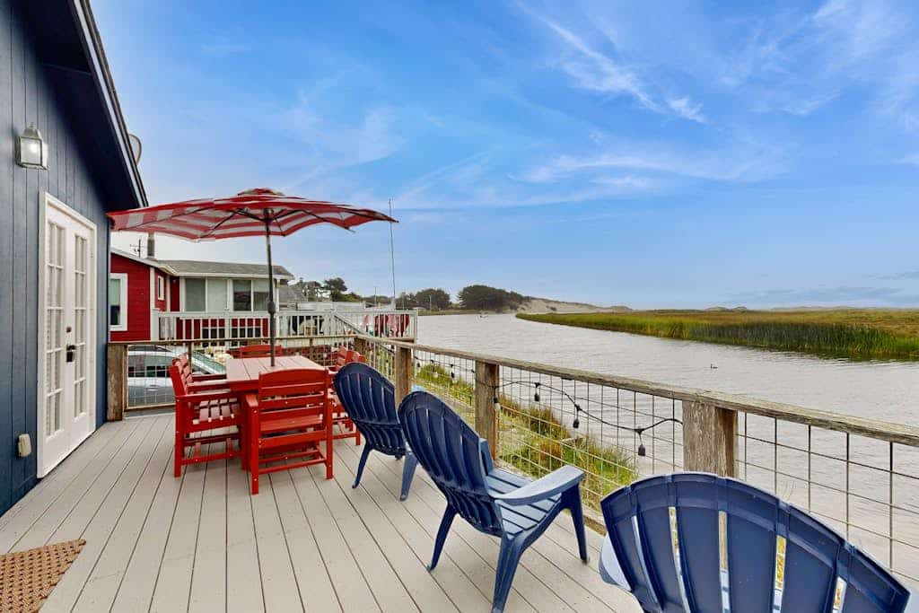 Salmon Creek flows past your deck as harbor seals play in the tidal waters below. Curl up by the gas fireplace with your pup after exploring the beach — just a short walk away. This intimate cottage for two sits directly on the water with sweeping views across the creek to distant hills. Spud Point's legendary crab sandwiches are 1.5 miles south. Your front door opens to the wild Sonoma Coast, where gray whales pass in winter and the sound of the Pacific carries on the breeze. 