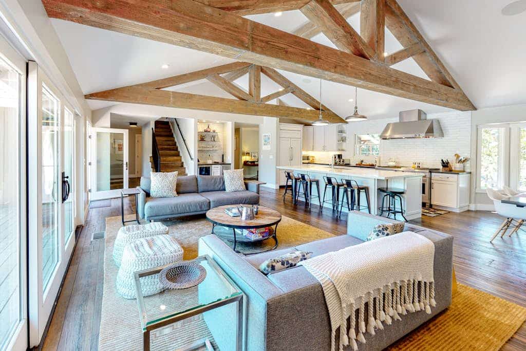 Sunlight streams through tall windows onto exposed wood beams and dark hardwood floors — this is modern wine country living with room to breathe. Four bedrooms, a pool, hot tub, and fire pit spread across landscaped grounds surrounded by mature trees, all just a five-minute drive from Sonoma Plaza and its 20-plus walkable tasting rooms. Buena Vista Winery and Gundlach Bundschu are each about a mile away. Gather your group and settle into Sonoma Valley the way it was meant to be.