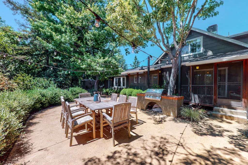 Sunlight streams through tall windows onto exposed wood beams and dark hardwood floors — this is modern wine country living with room to breathe. Four bedrooms, a pool, hot tub, and fire pit spread across landscaped grounds surrounded by mature trees, all just a five-minute drive from Sonoma Plaza and its 20-plus walkable tasting rooms. Buena Vista Winery and Gundlach Bundschu are each about a mile away. Gather your group and settle into Sonoma Valley the way it was meant to be.