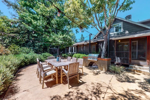 Sunlight streams through tall windows onto exposed wood beams and dark hardwood floors — this is modern wine country living with room to breathe. Four bedrooms, a pool, hot tub, and fire pit spread across landscaped grounds surrounded by mature trees, all just a five-minute drive from Sonoma Plaza and its 20-plus walkable tasting rooms. Buena Vista Winery and Gundlach Bundschu are each about a mile away. Gather your group and settle into Sonoma Valley the way it was meant to be.