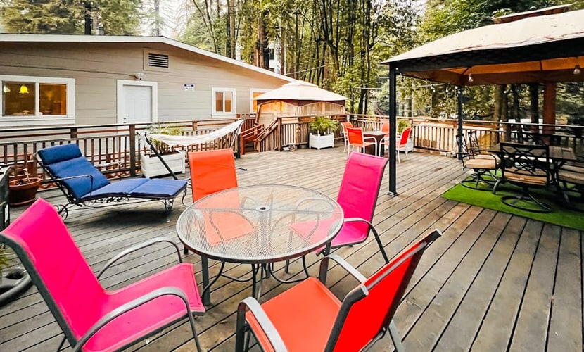 Soak in the private hot tub under towering redwoods after a short walk to the Russian River — this dog-friendly Rio Nido home sleeps 6 across 3 queen bedrooms, 500 feet from the under-road pathway to the water and steps from the Rio Nido Roadhouse.