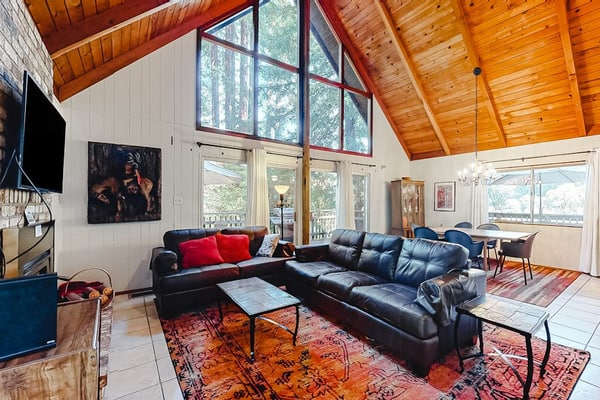 Redwood Lodge sleeps 4 adults across two bedrooms and a private loft sleeping area — with one of the bedrooms tucked off the garage for guests who'd rather have their own space. The wraparound deck looks out over the Russian River through redwood crowns. Steps from Northwood Golf Club, a mile from Monte Rio Beach, and dog-friendly. Out here, the only schedule that matters is sunrise and sunset.