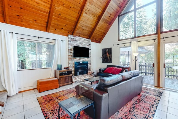 Redwood Lodge sleeps 4 adults across two bedrooms and a private loft sleeping area — with one of the bedrooms tucked off the garage for guests who'd rather have their own space. The wraparound deck looks out over the Russian River through redwood crowns. Steps from Northwood Golf Club, a mile from Monte Rio Beach, and dog-friendly. Out here, the only schedule that matters is sunrise and sunset.