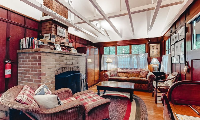 Wake to redwood light filtering across the deck of this dog-friendly cabin, a 3-minute walk from the neighborhood beach on the Russian River and 0.6 miles from downtown Guerneville. Soak in the private hot tub under the canopy, then warm up by the wood-burning fireplace inside. Two bedrooms and a twin sleep up to 5 in original clear-heart redwood rooms.