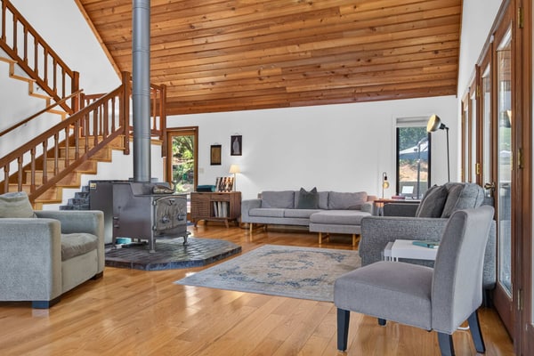 Light the wood stove, heat the spa whenever you like (free year-round), and let the redwoods do the rest — this Sebastopol hilltop home is built for cozy-season gatherings and up to four dogs. A wood-burning stove, a dining table for up to 10 (plus a round living-room table for 6 to 8 more), and a game room stocked with foosball and board games keep everyone happy when the weather turns. A chef's kitchen with espresso machine, fondue set, and popcorn popper means slow mornings and long dinners in. Sleeps 8 in four bedrooms. Marimar Estate 0.7 mi away.