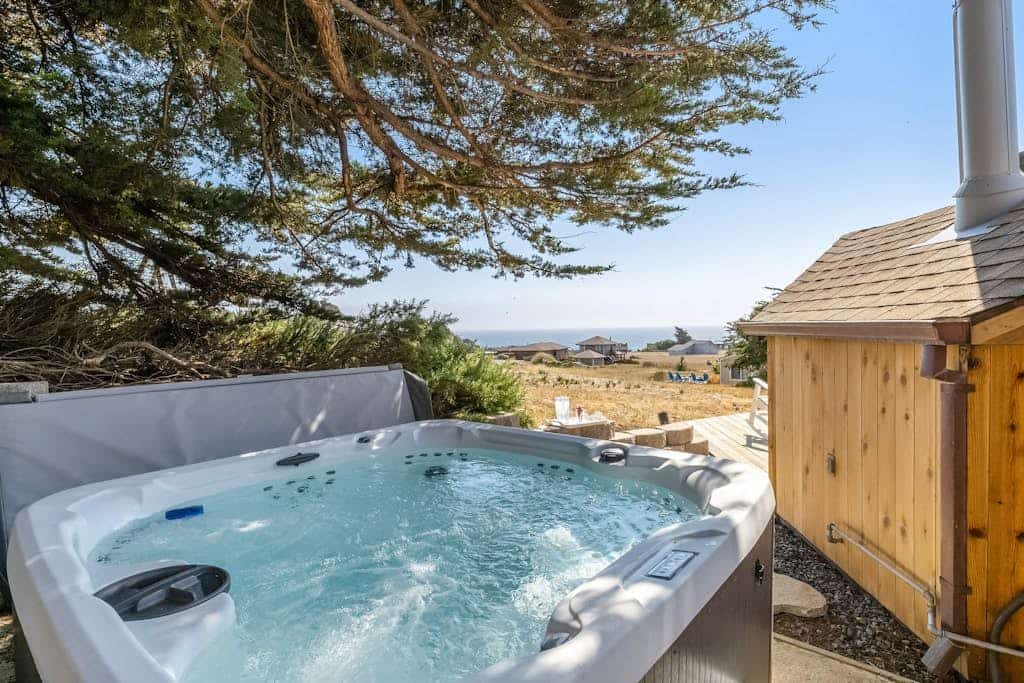 Sink into the hot tub beneath cypress trees as the sun melts into the Pacific, a few blocks inland from Portuguese Beach. This J. Carson Bowler-designed home frames coastal meadow and open ocean through walls of glass, with two king en-suite bedrooms sleeping 4. Bodega Bay's harbor and seafood shacks sit under five miles south; Jenner and the Russian River, seven miles north.