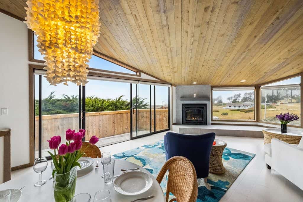 Sink into the hot tub beneath cypress trees as the sun melts into the Pacific, a few blocks inland from Portuguese Beach. This J. Carson Bowler-designed home frames coastal meadow and open ocean through walls of glass, with two king en-suite bedrooms sleeping 4. Bodega Bay's harbor and seafood shacks sit under five miles south; Jenner and the Russian River, seven miles north.