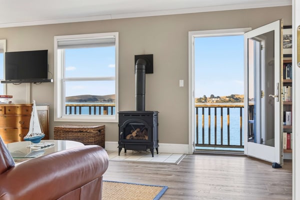 Wake to the cries of seabirds and watch fishing boats motor past from your waterfront perch. This intimate studio for two sits directly over Bodega Bay on weathered pilings — the water literally flows beneath you. Sip morning coffee on the narrow deck as harbor seals surface nearby. Just steps from Diekmann's Bay Store and The Boat House restaurant. An hour and a half from San Francisco, you'll find the coastal reset you've been craving.