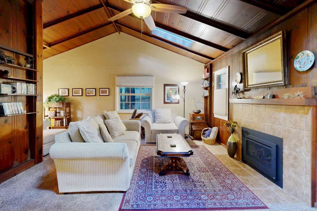 The scent of redwoods drifts through your windows as morning light filters through the forest canopy. Bring your dog to explore this unique retreat with its vintage knotty pine interiors and private fenced yard. Room for 4 across three distinct sleeping spaces. Just 200 feet from the Russian River and a 10-minute walk to downtown Guerneville's restaurants and shops. Cozy up to the gas fireplace after floating the river — this is the forest escape you've been craving.