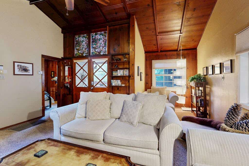 The scent of redwoods drifts through your windows as morning light filters through the forest canopy. Bring your dog to explore this unique retreat with its vintage knotty pine interiors and private fenced yard. Room for 4 across three distinct sleeping spaces. Just 200 feet from the Russian River and a 10-minute walk to downtown Guerneville's restaurants and shops. Cozy up to the gas fireplace after floating the river — this is the forest escape you've been craving.