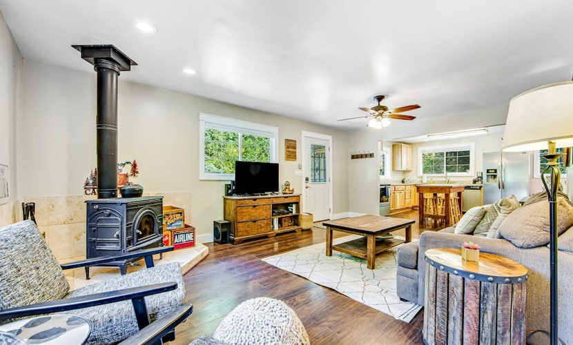 Wake to dappled orchard light through the bedroom's sliding glass door, step onto the deck with coffee, and point the day toward Russian River Valley AVA tasting rooms or a float at Steelhead Beach Regional Park 1.2 miles down the road. This dog-friendly Forestville home sleeps 4 between a king bedroom and a bunk room with four twins, with two decks, AC, WiFi, and a gas grill out back.