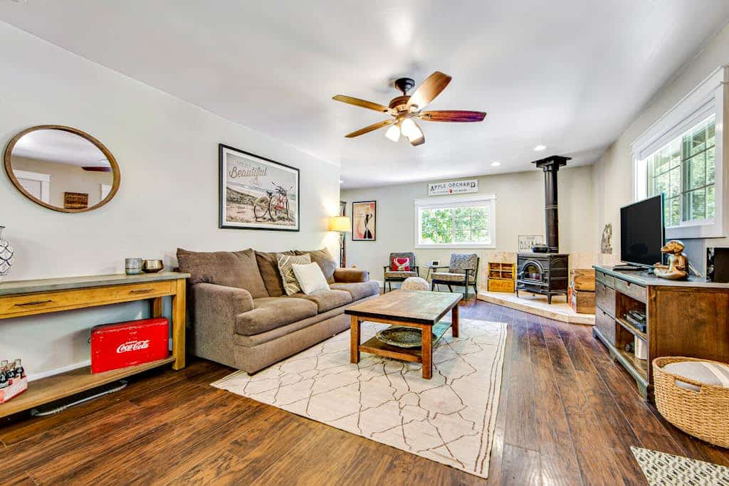 Wake to dappled orchard light through the bedroom's sliding glass door, step onto the deck with coffee, and point the day toward Russian River Valley AVA tasting rooms or a float at Steelhead Beach Regional Park 1.2 miles down the road. This dog-friendly Forestville home sleeps 4 between a king bedroom and a bunk room with four twins, with two decks, AC, WiFi, and a gas grill out back.