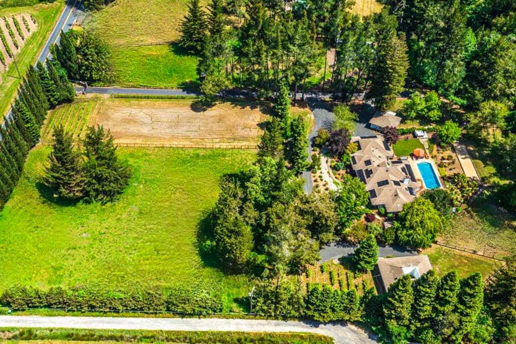 A 6-acre wine country compound with a heated pool, hot tub, private creek, and two buildings sleeping up to 14 across four bedrooms. The chef's kitchen, wood-burning fireplace, game room, and bocce court keep the group on-property as long as you want. Marimar Estate Vineyards is a third of a mile away; Graton's restaurants are five minutes; The Barlow and downtown Sebastopol are about 10 minutes by car.