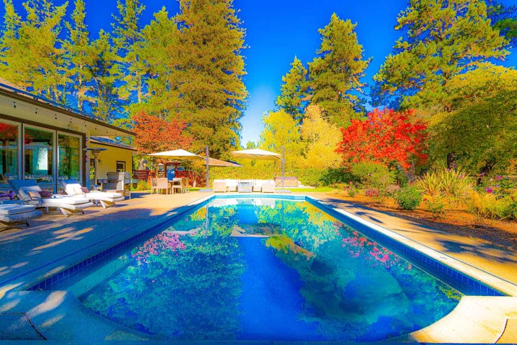 A 6-acre wine country compound with a heated pool, hot tub, private creek, and two buildings sleeping up to 14 across four bedrooms. The chef's kitchen, wood-burning fireplace, game room, and bocce court keep the group on-property as long as you want. Marimar Estate Vineyards is a third of a mile away; Graton's restaurants are five minutes; The Barlow and downtown Sebastopol are about 10 minutes by car.
