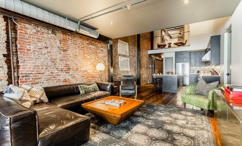 Stay in a stylish 4-bedroom, 4-bath downtown Nashville loft with exposed brick, a full kitchen, wet bar, and room for 14. Sleeping spaces include two king bedrooms, one queen bedroom, and a bunk room with four queen beds. Restaurants and entertainment are within walking distance. Please note: the building has no elevator, and parking is paid off-site.