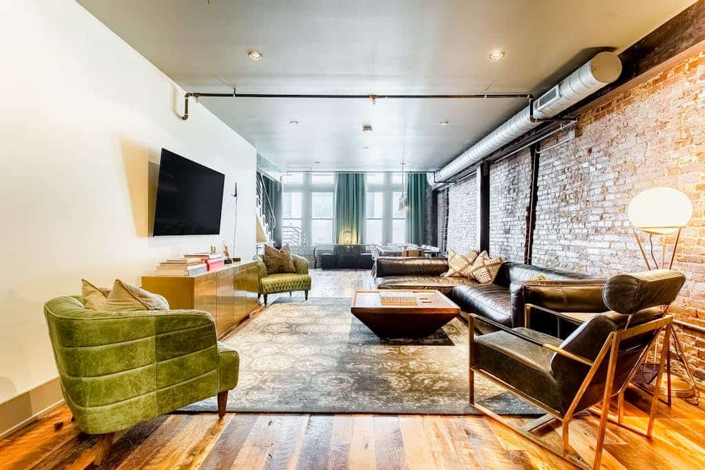Stay in a stylish 4-bedroom, 4-bath downtown Nashville loft with exposed brick, a full kitchen, wet bar, and room for 14. Sleeping spaces include two king bedrooms, one queen bedroom, and a bunk room with four queen beds. Restaurants and entertainment are within walking distance. Please note: the building has no elevator, and parking is paid off-site.