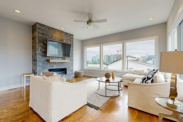 Modern 4-bedroom retreat with a private rooftop deck, city views, spacious living areas, gourmet kitchen, private 2-car garage, and convenient access to Downtown Nashville, The Gulch, Music Row, and 12South.