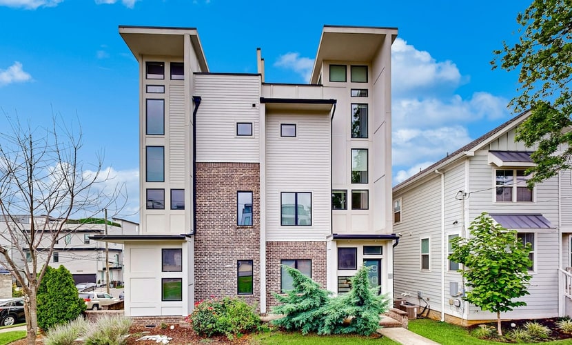 Modern 4-bedroom retreat with a private rooftop deck, city views, spacious living areas, gourmet kitchen, private 2-car garage, and convenient access to Downtown Nashville, The Gulch, Music Row, and 12South.