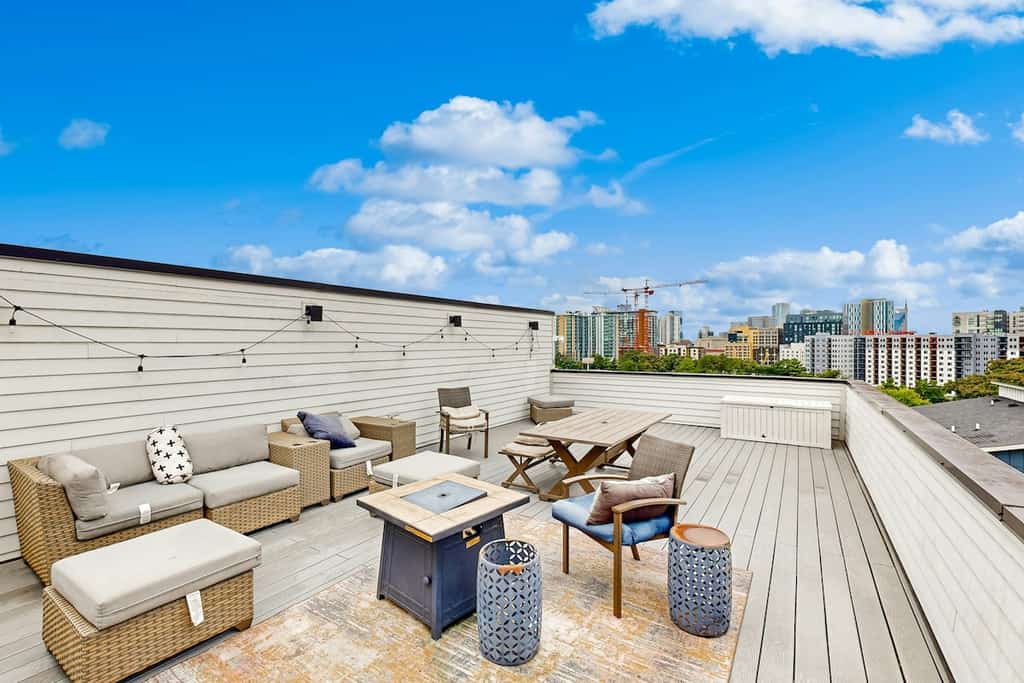Modern 4-bedroom retreat with a private rooftop deck, city views, spacious living areas, gourmet kitchen, private 2-car garage, and convenient access to Downtown Nashville, The Gulch, Music Row, and 12South.