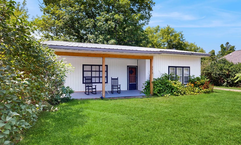 Welcome to your cozy up-north getaway in the heart of Lake Leelanau. This charming 2-bedroom, 1-bath bungalow sits just up the hill from Main Street—close to everything, yet peaceful and quiet.
You can walk to four tasting rooms (three wineries and one distillery), four restaurants, two ice cream shops, two parks, a market, unique shops, and a charming coffee shop. Lake Leelanau public access is just three minutes away, and two kayaks are available for guest use so you can enjoy time on the water.
The location makes exploring easy. Downtown Leland and historic Fishtown are just 5.3 miles away. Downtown Suttons Bay is 10 minutes away, Glen Arbor is just over 20 minutes, and Traverse City is less than 30 minutes, giving you quick access to beaches, shops, and events across the peninsula.
The home comfortably sleeps couples or families with two bedrooms, each featuring a full bed, plus a full sofa bed in the living room. A fully equipped kitchen, washer and dryer, open-concept living and dining area, and a large covered front porch make it easy to settle in. Strong WiFi and two Roku TVs allow you to stream your favorite shows after a day of adventure. Mini-split systems provide efficient heating and partial air conditioning, and multiple ceiling fans and screened windows bring in the refreshing northern Michigan breeze.
For guests who like to stay active, a Peloton bike is also available for your use during your stay.
Traveling with kids? They'll enjoy two kid-sized tables—one near the kitchen and one in the foyer for coloring—along with puzzles and children's books provided during your stay.
Whether you're kayaking at sunrise, wine tasting in the afternoon, riding the Peloton before heading out, or enjoying ice cream after dinner, this bungalow is the perfect home base for your Leelanau Peninsula escape.
VueStay Vacations manages this property. Michigan Real Estate license #6505433797.