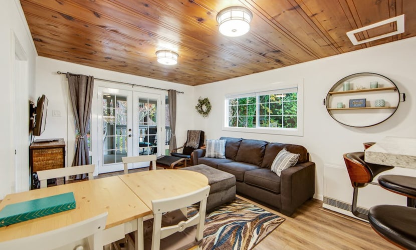 Soak in the redwood-shaded hot tub after a day on the Russian River, less than two miles from downtown Guerneville's restaurants and Johnson's Beach. This dog-friendly cottage sleeps 4 across two queen bedrooms, with a wraparound deck, gas grill, and fully remodeled kitchen tucked into the trees.
