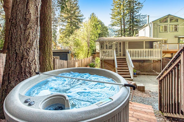 Soak in the redwood-shaded hot tub after a day on the Russian River, less than two miles from downtown Guerneville's restaurants and Johnson's Beach. This dog-friendly cottage sleeps 4 across two queen bedrooms, with a wraparound deck, gas grill, and fully remodeled kitchen tucked into the trees.
