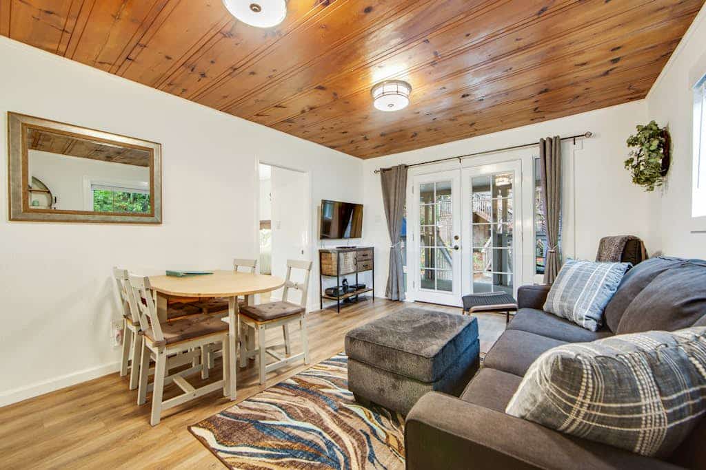 Soak in the redwood-shaded hot tub after a day on the Russian River, less than two miles from downtown Guerneville's restaurants and Johnson's Beach. This dog-friendly cottage sleeps 4 across two queen bedrooms, with a wraparound deck, gas grill, and fully remodeled kitchen tucked into the trees.