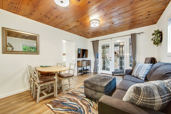 Soak in the redwood-shaded hot tub after a day on the Russian River, less than two miles from downtown Guerneville's restaurants and Johnson's Beach. This dog-friendly cottage sleeps 4 across two queen bedrooms, with a wraparound deck, gas grill, and fully remodeled kitchen tucked into the trees.