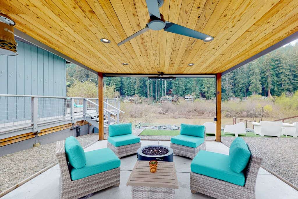The Russian River flows past your deck while you soak in the hot tub under towering redwoods. This vibrant mid-century home welcomes you and your pup with bold turquoise furnishings and a covered outdoor lounge complete with firepit and TV. Sleeps 6 across three bedrooms. Just a half-mile stroll to Monte Rio Beach and the town's beloved ice cream shop. Settle into river time where the only agenda is watching the water flow by and the redwoods sway overhead.