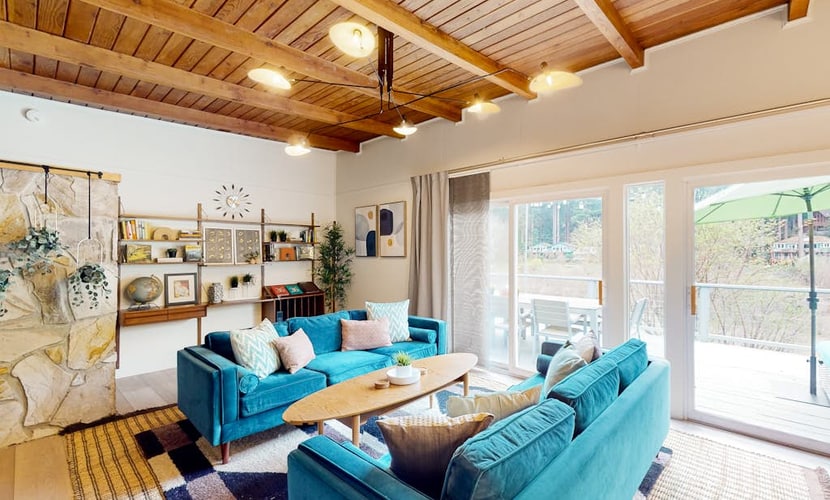 The Russian River flows past your deck while you soak in the hot tub under towering redwoods. This vibrant mid-century home welcomes you and your pup with bold turquoise furnishings and a covered outdoor lounge complete with firepit and TV. Sleeps 6 across three bedrooms. Just a half-mile stroll to Monte Rio Beach and the town's beloved ice cream shop. Settle into river time where the only agenda is watching the water flow by and the redwoods sway overhead.