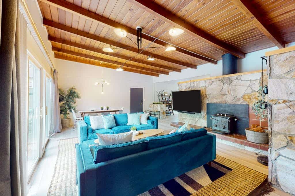 The Russian River flows past your deck while you soak in the hot tub under towering redwoods. This vibrant mid-century home welcomes you and your pup with bold turquoise furnishings and a covered outdoor lounge complete with firepit and TV. Sleeps 6 across three bedrooms. Just a half-mile stroll to Monte Rio Beach and the town's beloved ice cream shop. Settle into river time where the only agenda is watching the water flow by and the redwoods sway overhead.