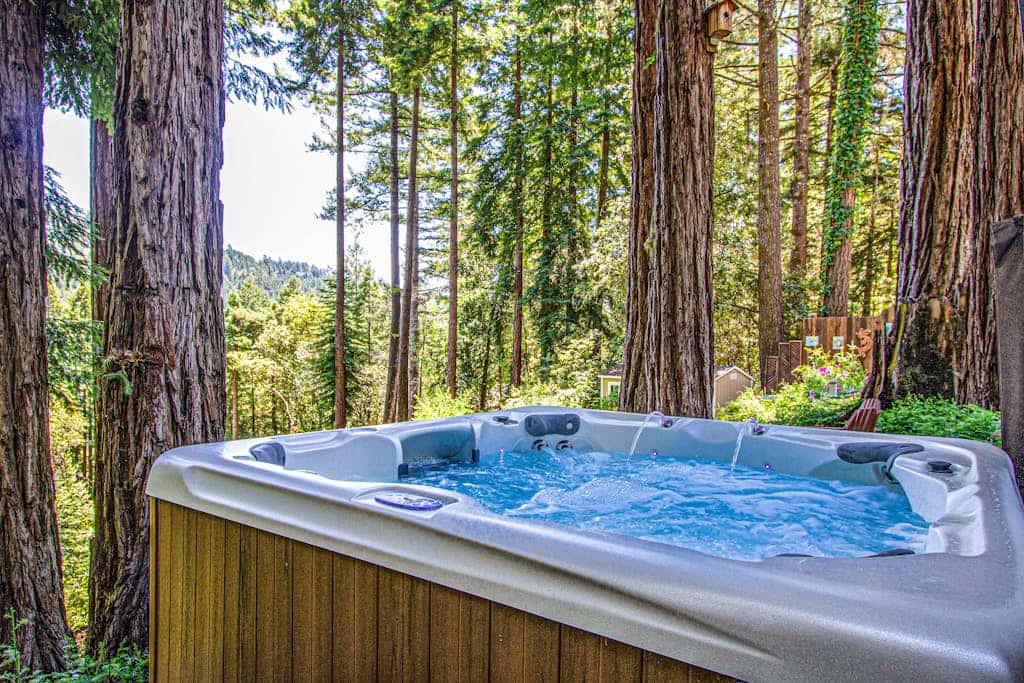 Soak in the hot tub as redwood shadows lengthen across the deck of this dog-friendly hillside home, ten minutes off the highway but a world away near Cazadero. Four bedrooms and three baths sleep eight, with a gas fireplace inside and a deck out back. Northwood Golf Club sits 8 miles down the road; Armstrong Redwoods and the Sonoma Coast are within a half-hour drive.